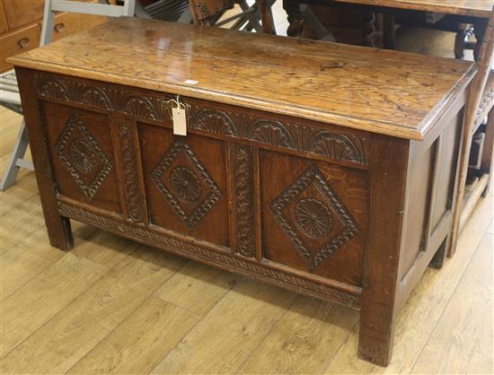 An 18th century carved oak coffer, W.124cm